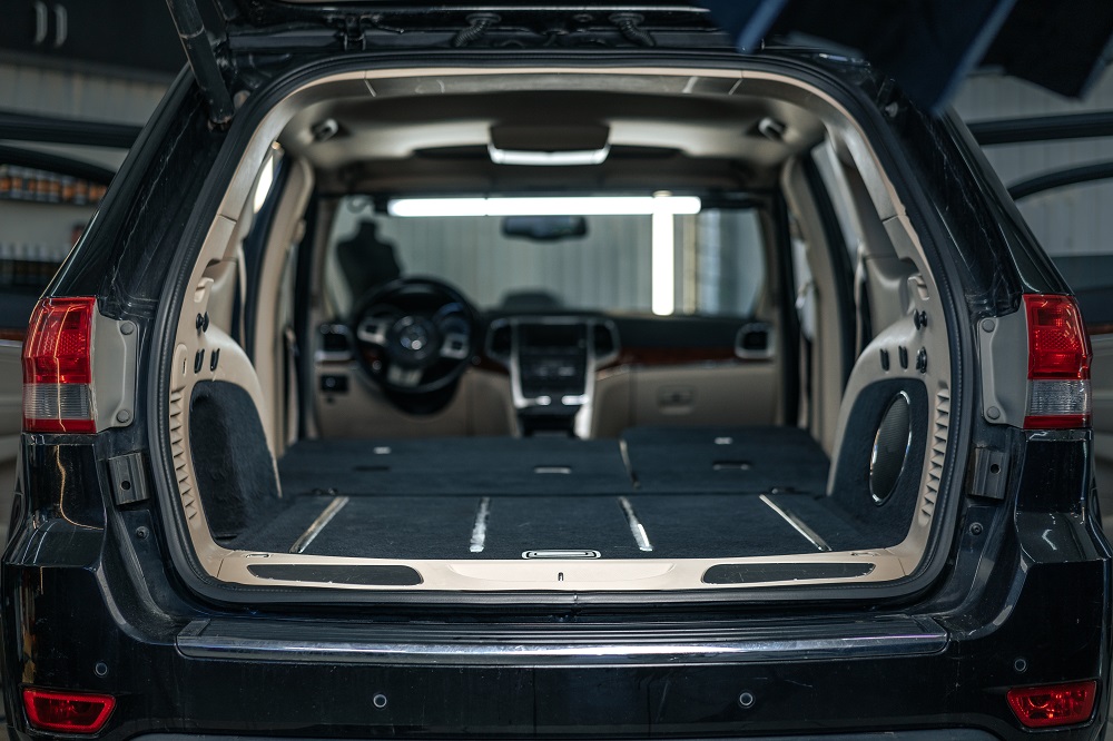  Open rear view of an SUV with the back seats folded down, showing an expanded cargo area—perfect for hauling gear or shopping in LA. Discover more spacious options like this at Custom Cars in Mandeville.